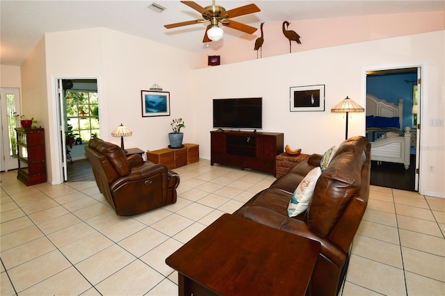 living room with vaulted ceiling, light tile patterned floors, and ceiling fan