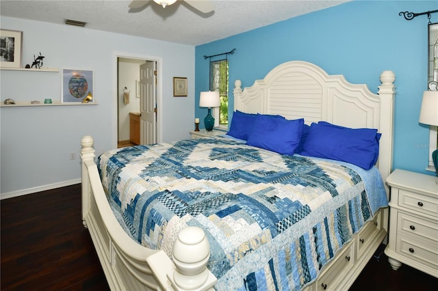 bedroom with a textured ceiling, ensuite bathroom, ceiling fan, and dark hardwood / wood-style floors