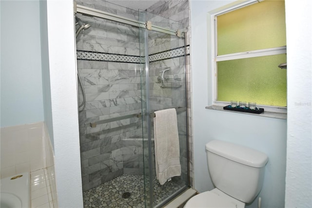 bathroom featuring walk in shower and toilet