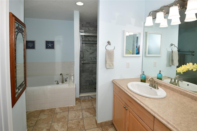 bathroom with shower with separate bathtub, vanity, a textured ceiling, and tile patterned flooring