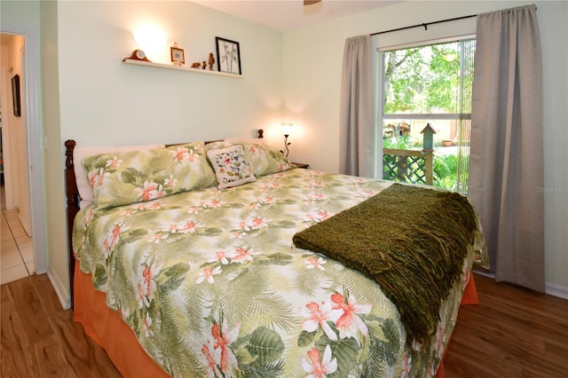 bedroom with dark hardwood / wood-style floors