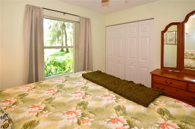 bedroom with ceiling fan and a closet