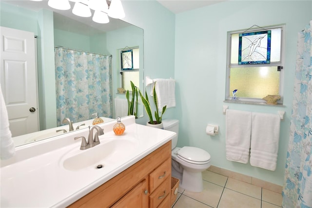 bathroom with tile patterned flooring, vanity, and toilet