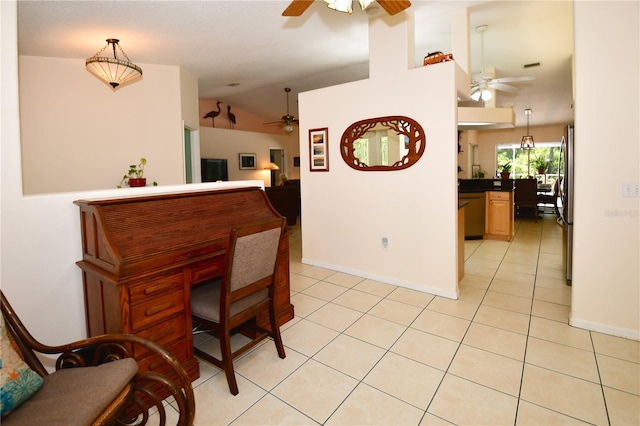 dining space featuring ceiling fan, light tile patterned floors, and lofted ceiling