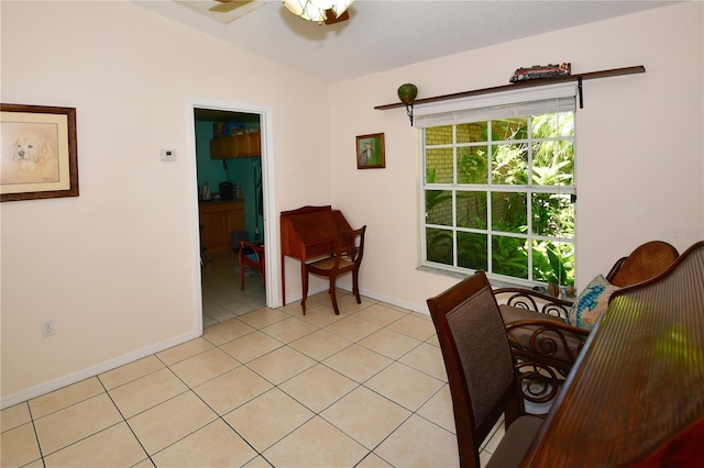 living area featuring light tile patterned flooring, ceiling fan, and vaulted ceiling