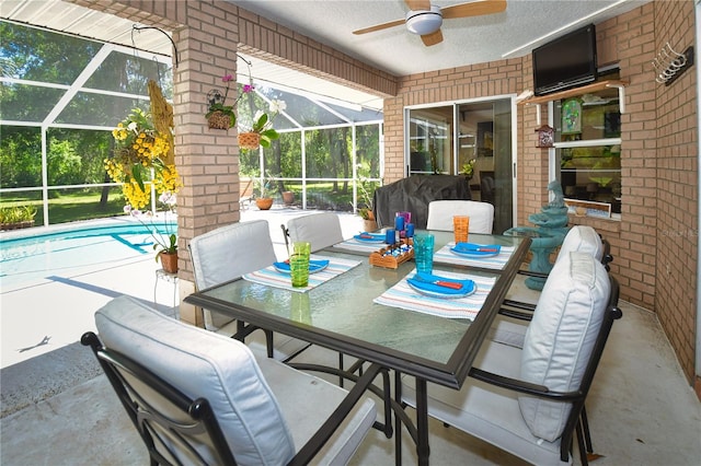 view of patio / terrace with grilling area, a lanai, and ceiling fan