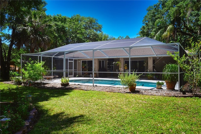 back of house with a yard and glass enclosure