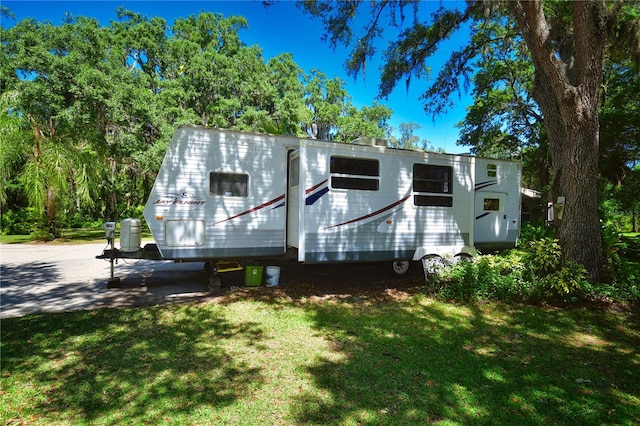 back of property featuring a lawn