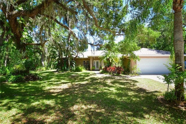 ranch-style house with a garage and a front lawn