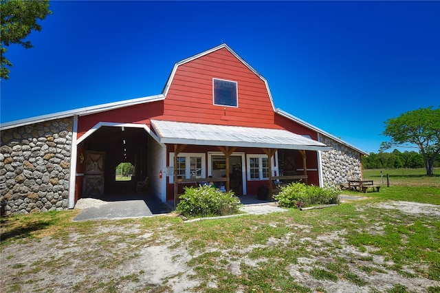 back of house featuring a porch and a yard