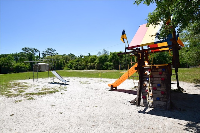 view of playground with a lawn