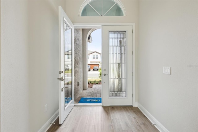 entrance foyer featuring baseboards and light wood-style floors