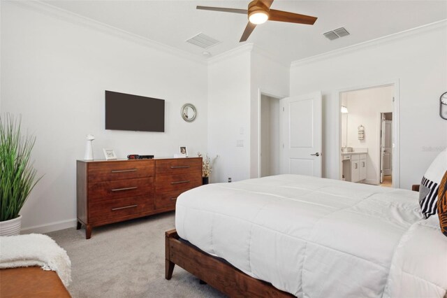 bedroom featuring ceiling fan, light colored carpet, ornamental molding, and ensuite bathroom