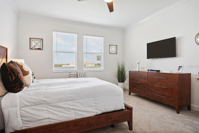 carpeted bedroom with ceiling fan and crown molding