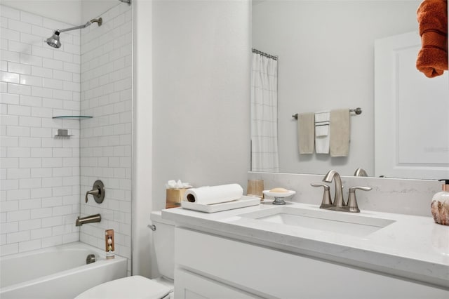 full bathroom with vanity, tiled shower / bath combo, and toilet