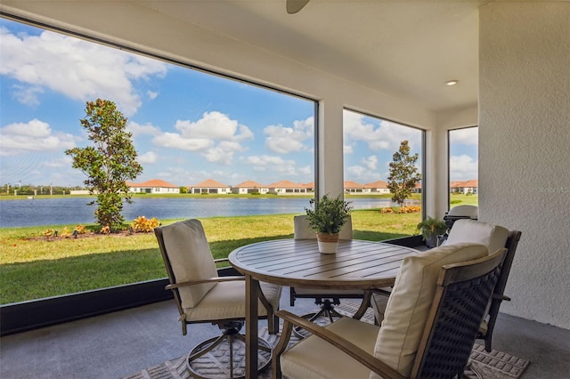 sunroom / solarium with a water view