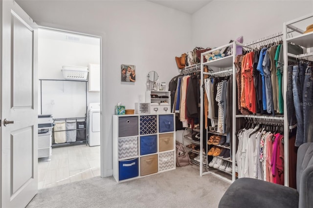 walk in closet featuring carpet flooring and washer / clothes dryer