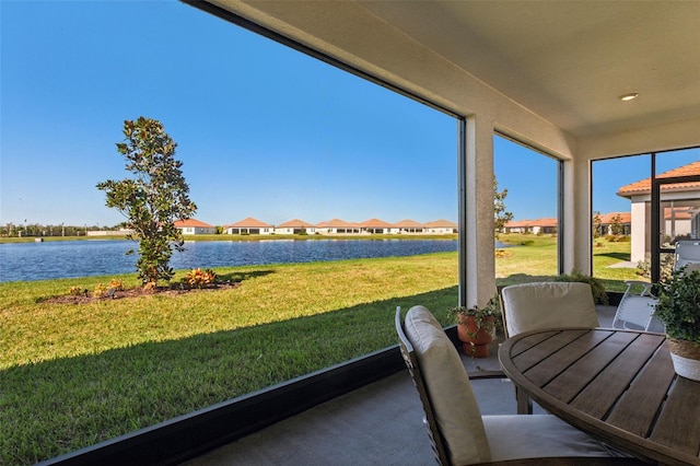 unfurnished sunroom featuring a water view