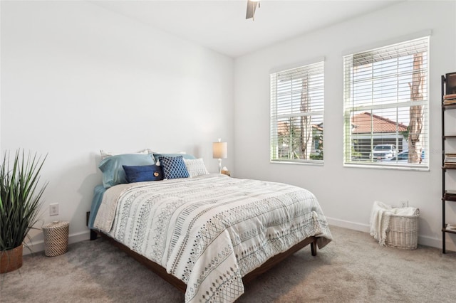 bedroom featuring ceiling fan and carpet