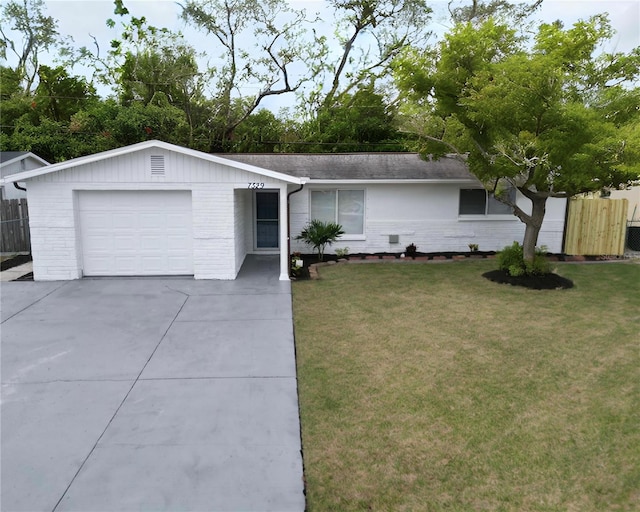 ranch-style home featuring a garage and a front lawn