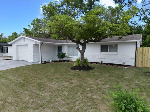 single story home featuring a garage and a front yard