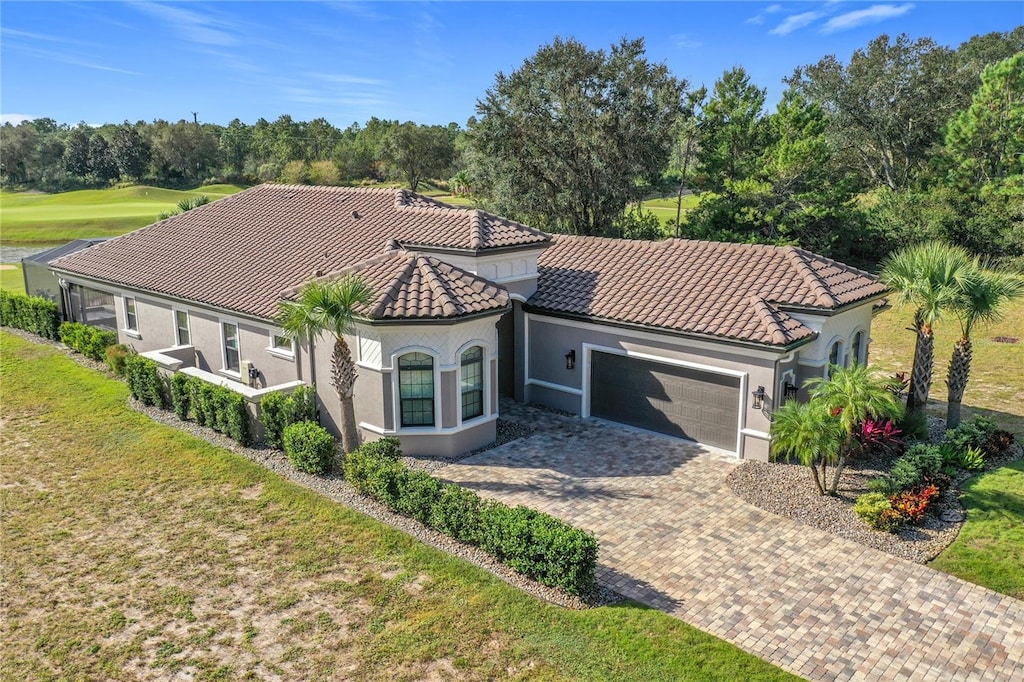 view of front of home featuring a garage and a front lawn