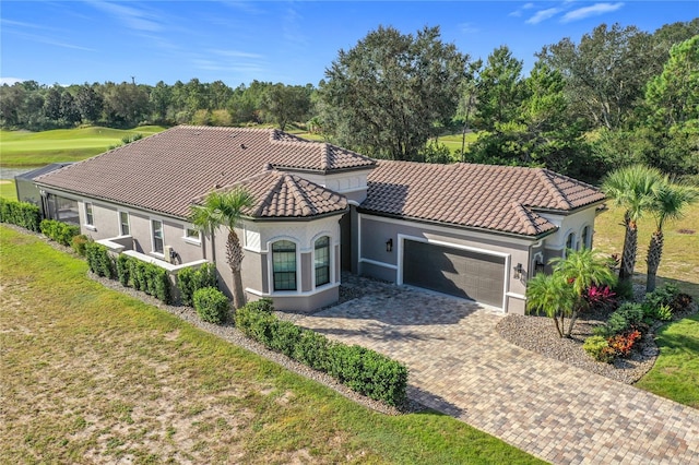 view of front of home featuring a garage and a front lawn