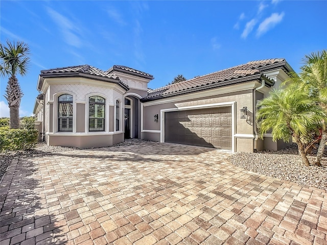 mediterranean / spanish-style house with a garage