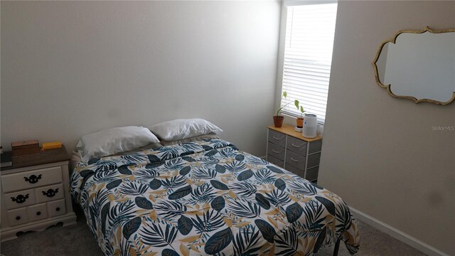 carpeted bedroom featuring multiple windows