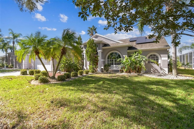 view of front of property with a front lawn, a garage, and solar panels