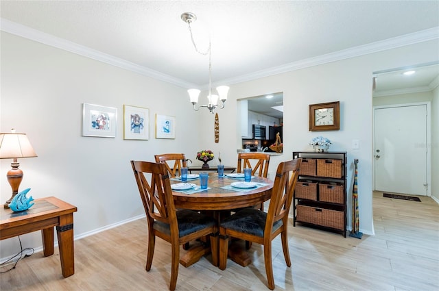 dining area featuring a chandelier, light wood-type flooring, and ornamental molding