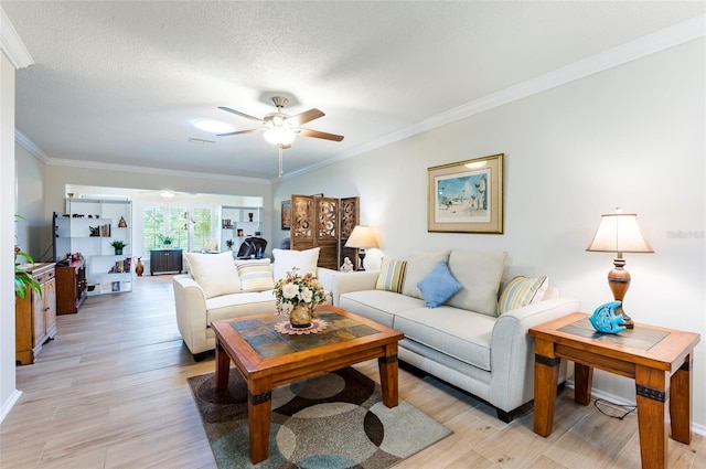 living room with ornamental molding, ceiling fan, and light hardwood / wood-style flooring