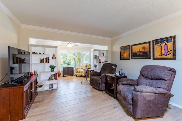 living room featuring ceiling fan, a textured ceiling, light wood-type flooring, and ornamental molding