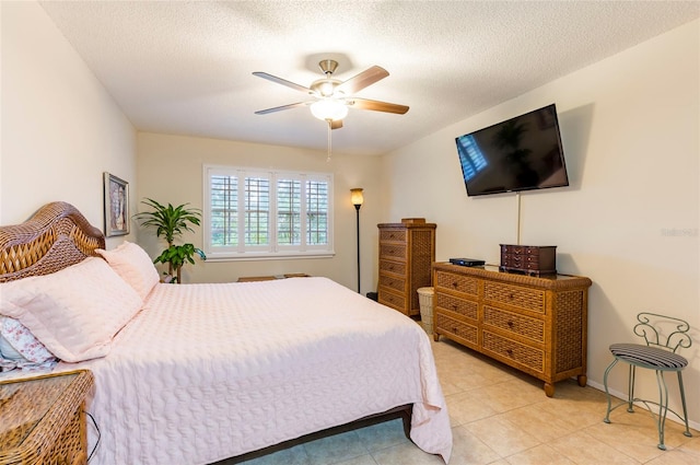 tiled bedroom with a textured ceiling and ceiling fan