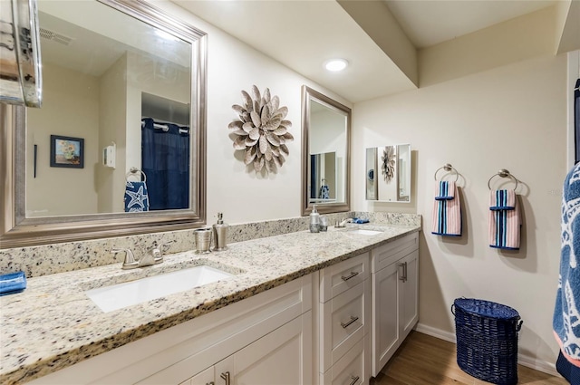 bathroom featuring wood-type flooring and vanity