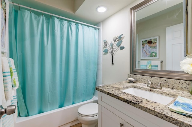 full bathroom featuring toilet, shower / tub combo with curtain, and vanity