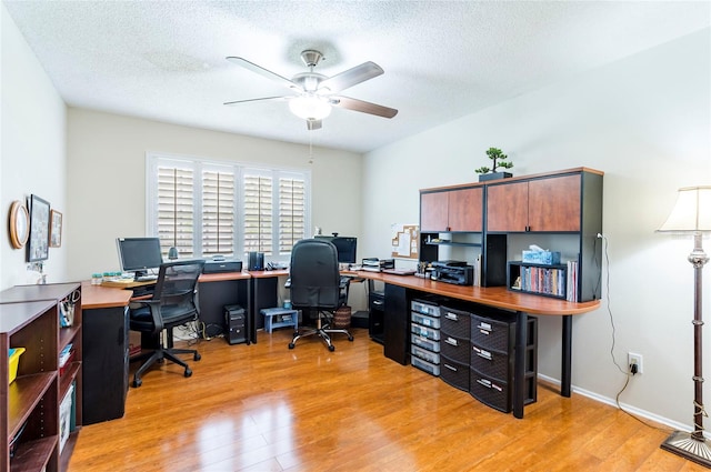 office area featuring ceiling fan, a textured ceiling, and light wood-type flooring