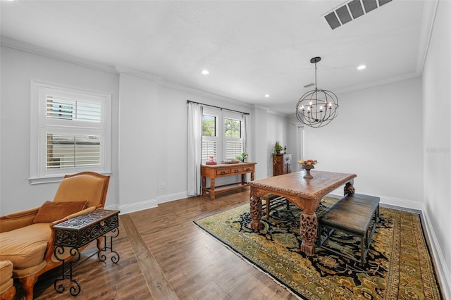 dining room featuring hardwood / wood-style flooring, crown molding, and an inviting chandelier