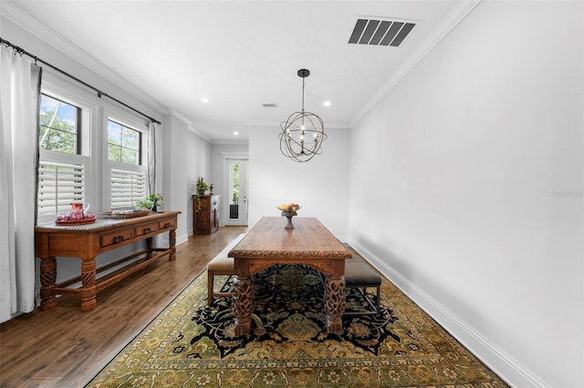 dining area featuring a chandelier, hardwood / wood-style floors, and ornamental molding