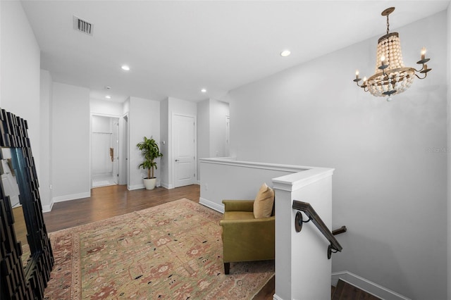 sitting room featuring dark hardwood / wood-style flooring and a notable chandelier