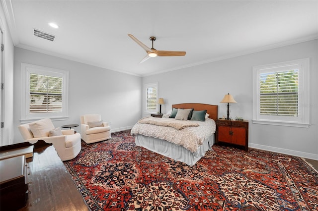 bedroom with ceiling fan, multiple windows, and crown molding