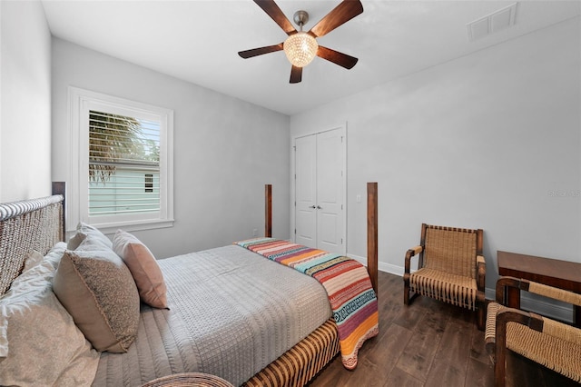 bedroom featuring dark wood-type flooring, a closet, and ceiling fan