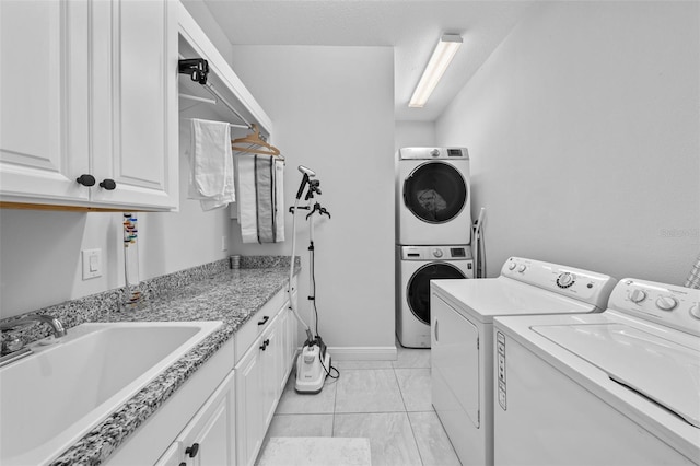 laundry area featuring cabinets, separate washer and dryer, a textured ceiling, and sink