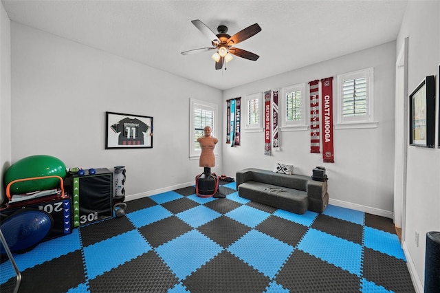 exercise room with ceiling fan