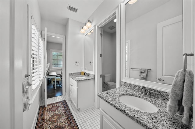 bathroom with hardwood / wood-style floors, vanity, and toilet