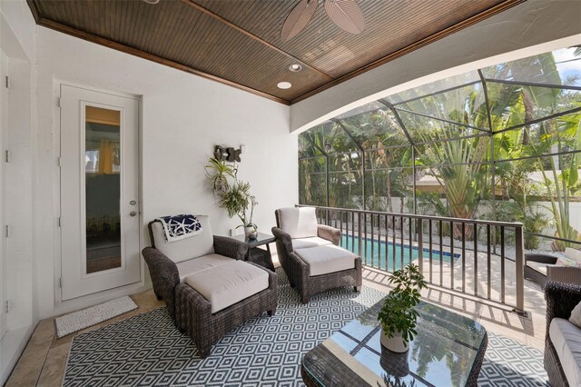 view of patio / terrace featuring glass enclosure and ceiling fan