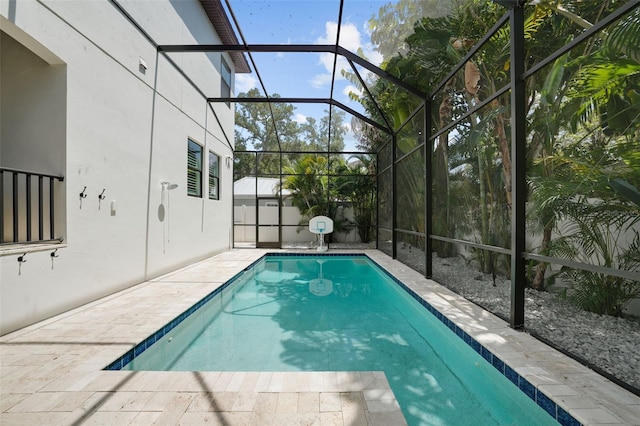 view of pool featuring glass enclosure and a patio area