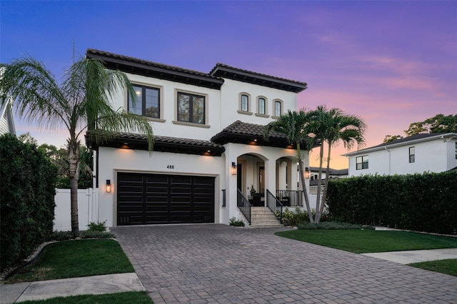 mediterranean / spanish-style home with a garage