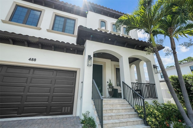 property entrance featuring a garage and covered porch