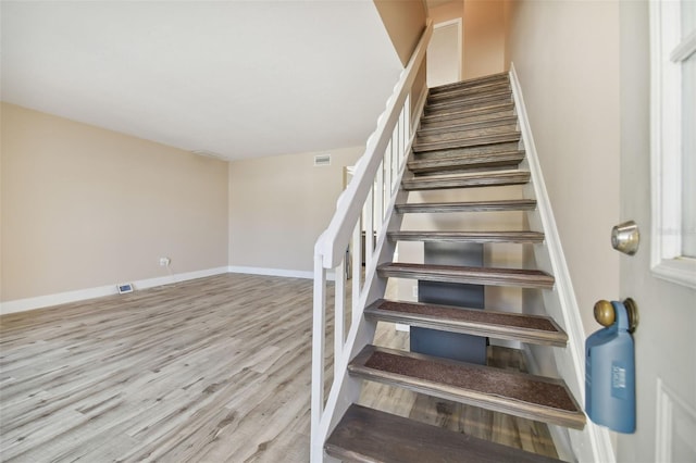 staircase featuring wood-type flooring